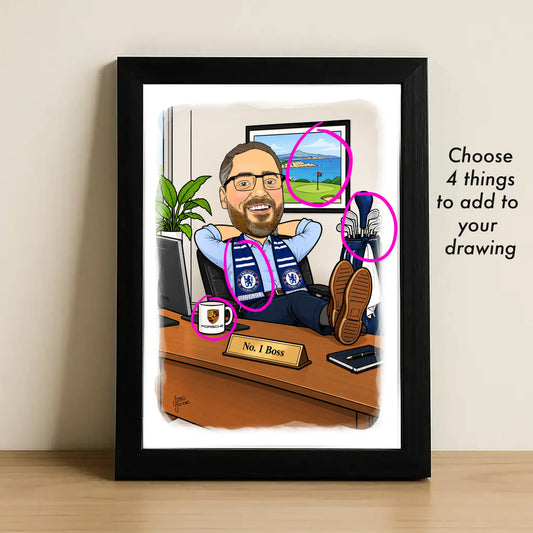 A framed custom caricature illustration leaning against a wall on a wooden surface. The artwork shows a man at a desk with soccer-themed details, and the image includes overlaid pink circles and text reading 'Choose 4 things to add to your drawing.