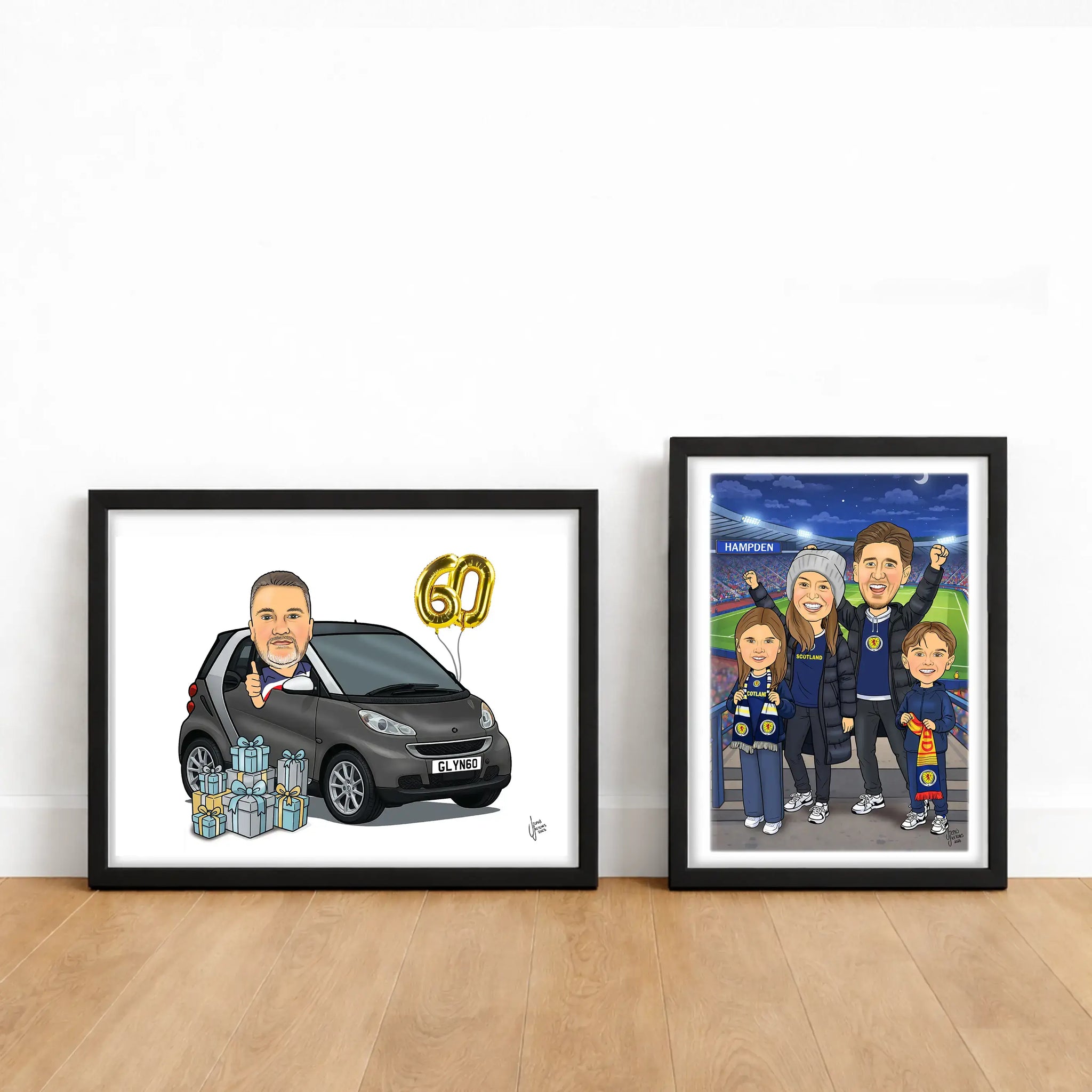 Two framed caricatures on a wooden floor against a white wall.