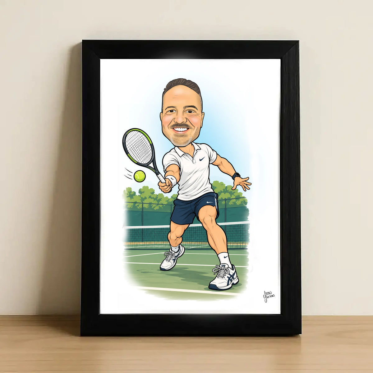 A framed caricature art print of a tennis player, leaning against a neutral wall on a light wooden surface. The print features a cartoon illustration of a man in a white polo shirt and navy shorts on a tennis court, enclosed in a black frame.